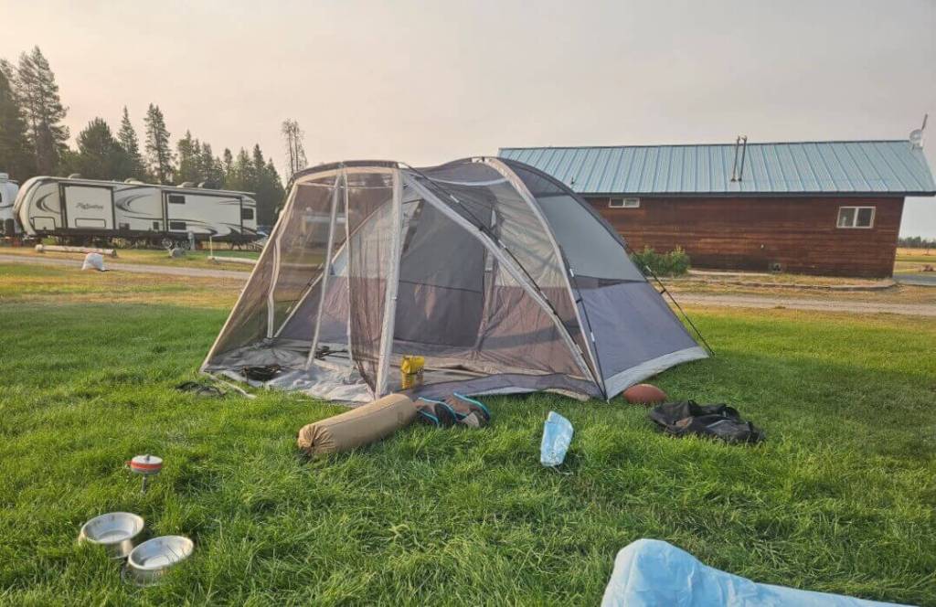 A grey tent in an RV park.