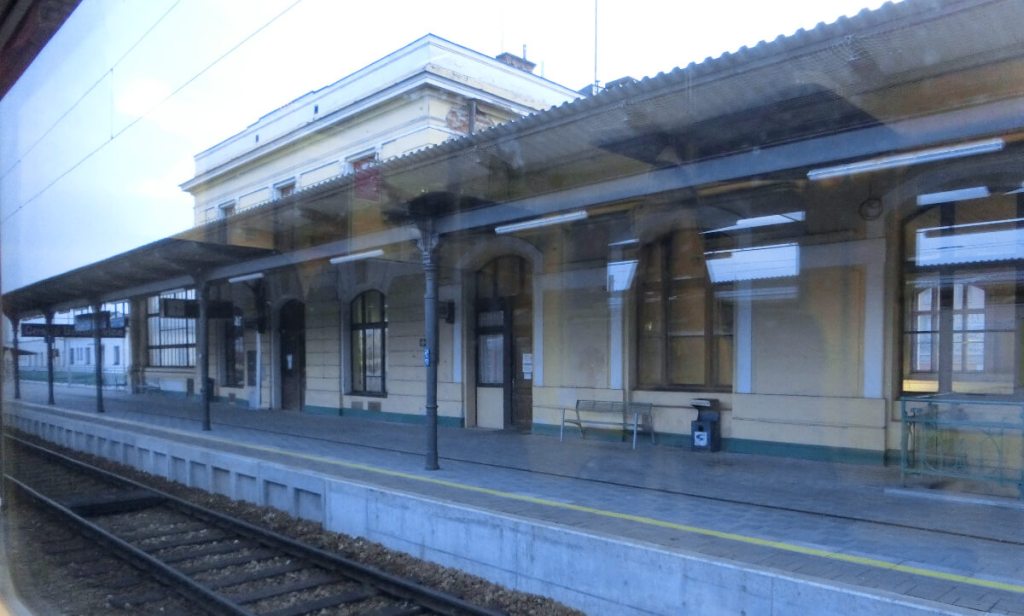 a photo of a train station in Trebon, Czechia taken through the train window.