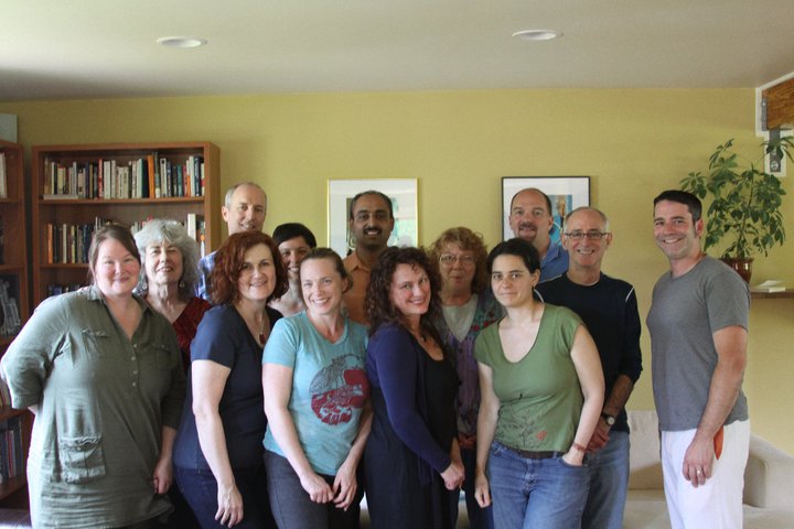 A group of people smiling for a group photo.