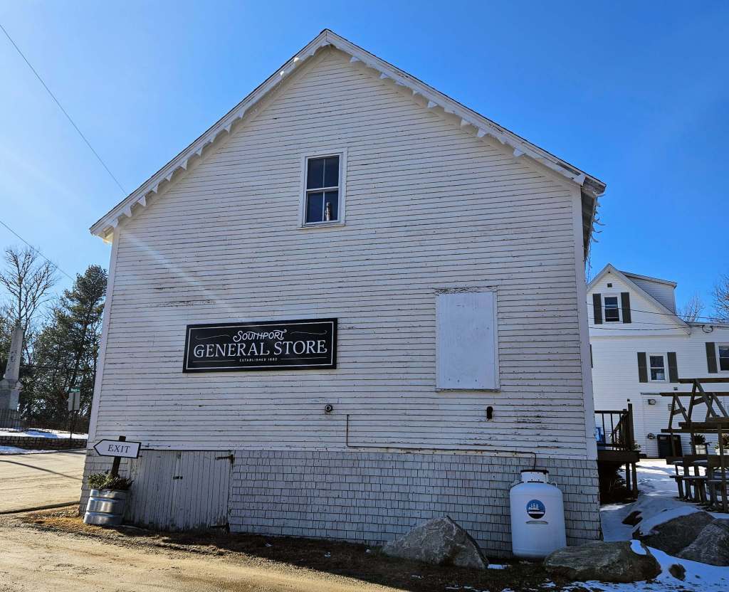 A white a-frame house with the sign: Southport General Store.